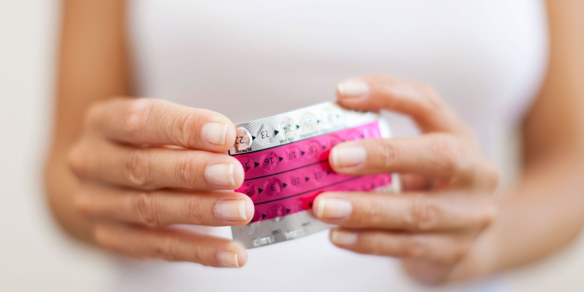 Woman's hands holding contraceptive pill packet